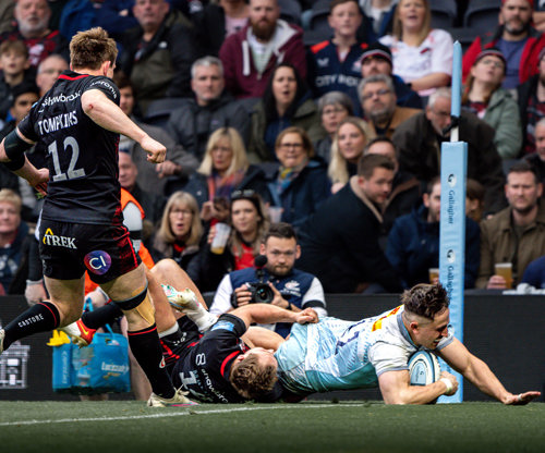 A Harlequins player scores a try against Saracens in the Showdown 3 match at Tottenham Hotspur Stadium